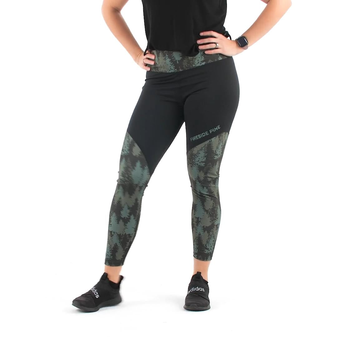 Crafted with care from a premium blend of materials. With a mid to high-rise waist, they provide just the right amount of coverage and support. The 7/8 length design adds a trendy touch to your look. These leggings feature a green and black color scheme graphic pine tree pattern. Model Fit Video.